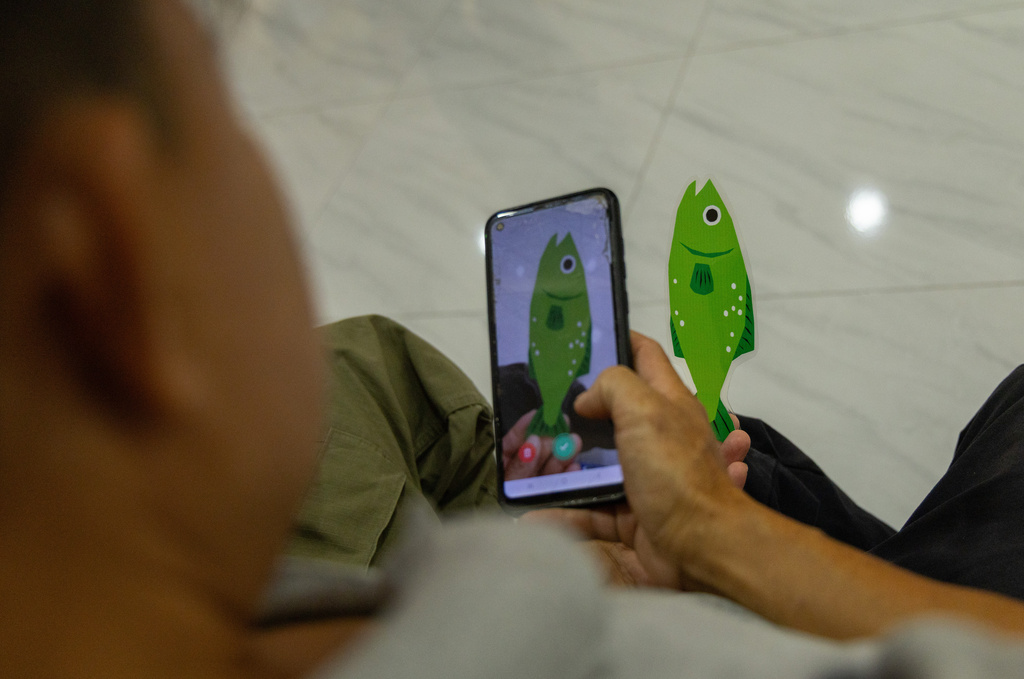 A fisherman practices using a new fish safety app during a training session in Chiang Saen, Thailand, on Feb. 17, 2026. (AP Photo/Anton L. Delgado)