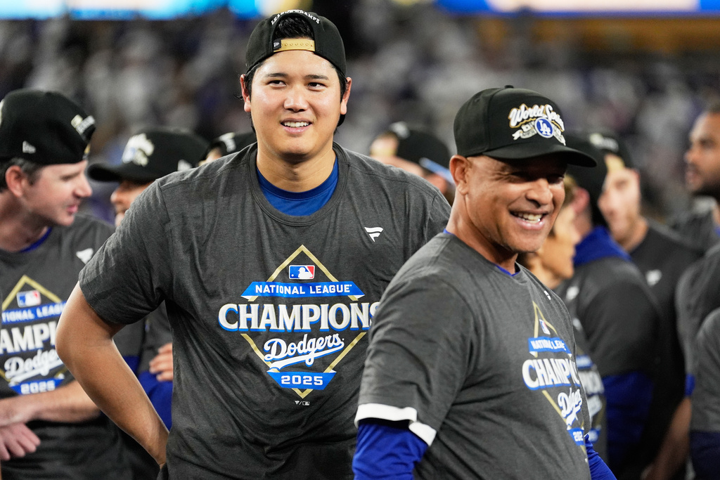 Los Angeles Dodgers pitcher Shohei Ohtani and manager Dave Roberts celebrate their win against the Milwaukee Brewers in baseball's National League Championship Series, Friday, Oct. 17, 2025, in Los Angeles. (AP Photo/Brynn Anderson)