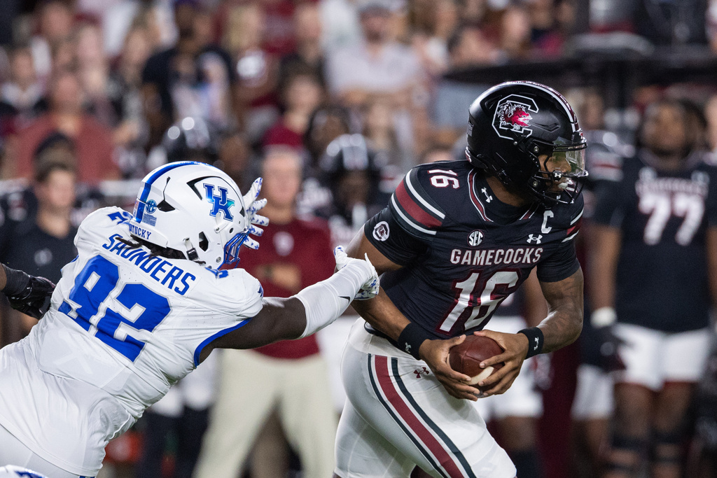 South Carolina quarterback LaNorris Sellers (16) gets away from Kentucky defensive lineman Kahlil Saunders (92) during the first half of an NCAA college football game, Saturday, Sept. 27, 2025, in Columbia, S.C. (AP Photo/Scott Kinser)