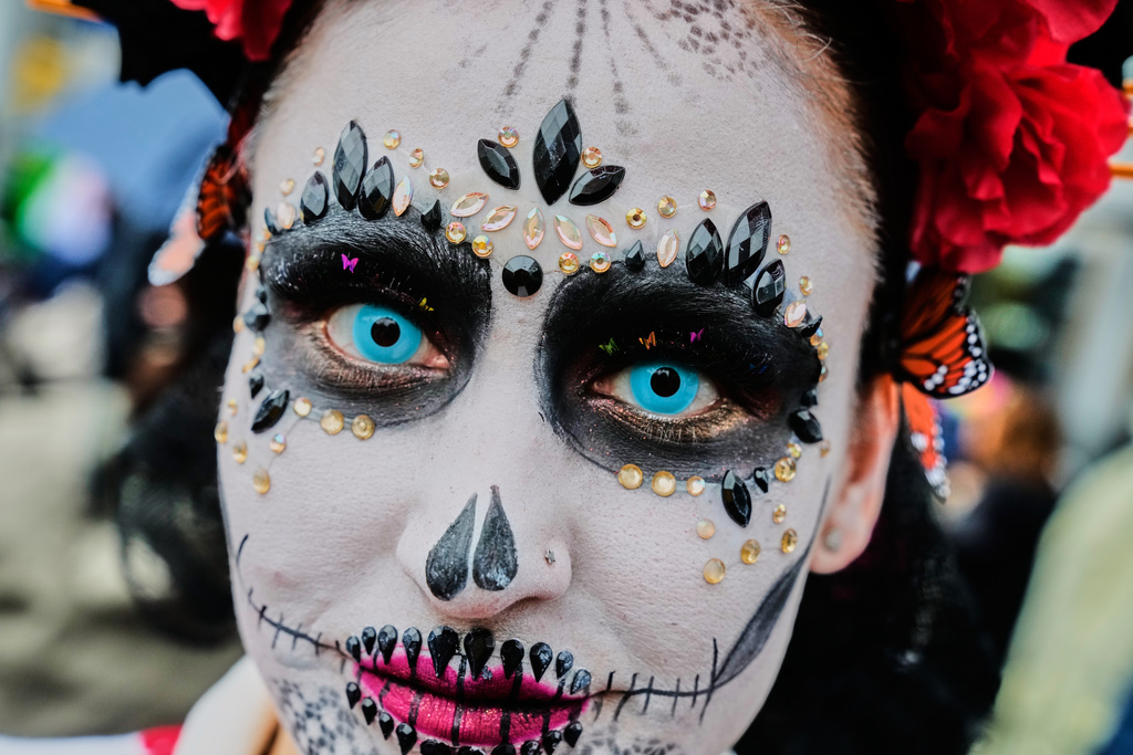 A woman attends the traditional Catrina parade marking the Day of the Dead in Frankfurt, Germany, Saturday, Nov. 1, 2025. (AP Photo/Michael Probst)