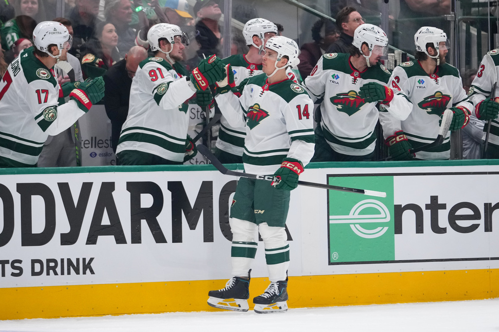 Minnesota Wild center Joel Eriksson Ek (14) skates by his bench after scoring a power play goal against the Dallas Stars during the first period in Game 1 of a first-round NHL Stanley Cup playoffs hockey series, Saturday, April 18, 2026, in Dallas, Texas. (AP Photo/Julio Cortez)