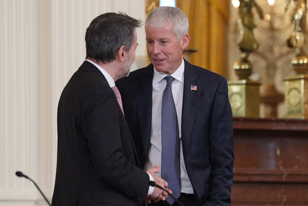 Energy Secretary Chris Wright talks with Josu Jon Imaz, CEO of Repsol, before President Donald Trump speaks during a meeting with oil executives in the East Room of the White House, Friday, Jan. 9, 2026, in Washington. (AP Photo/Evan Vucci)