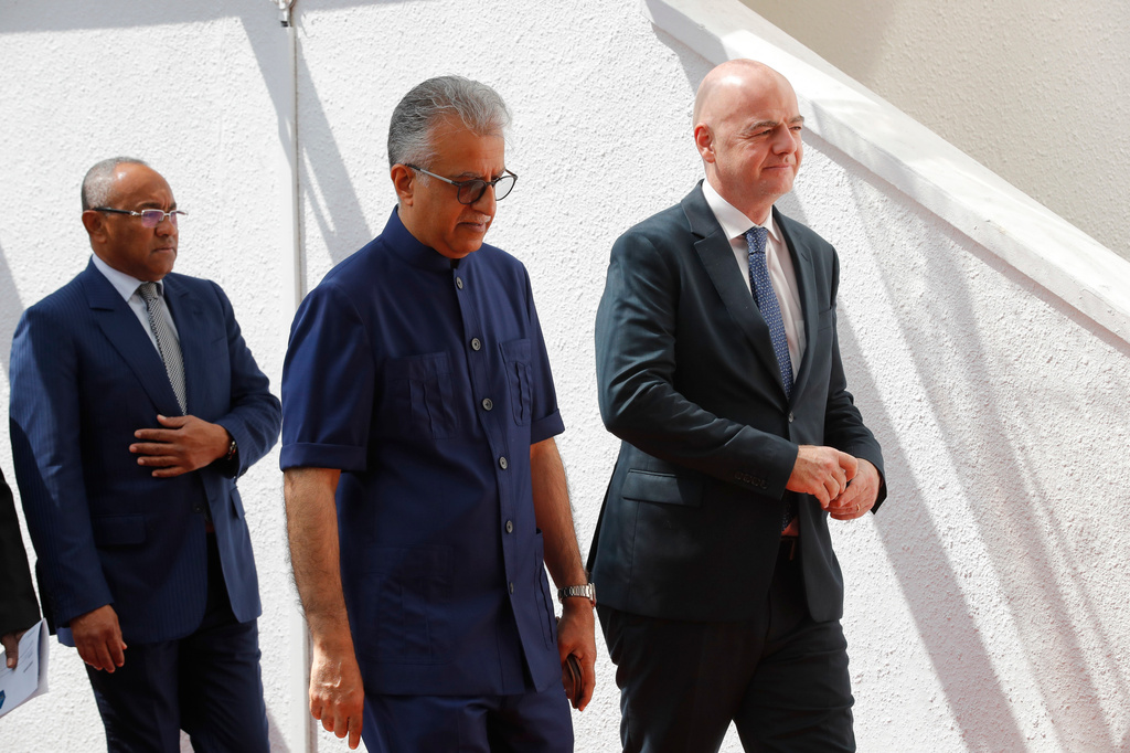 FILE - Asia Football Confederation President Salman Bin Ibrahim Al-Khalifa, center, walks with FIFA President Gianni Infantino, right, as they arrive for an inauguration ceremony for the new building of the Asia Football Confederation in Kuala Lumpur, Malaysia Tuesday, Oct. 30, 2018. (AP Photo/Vincent Thian, File)