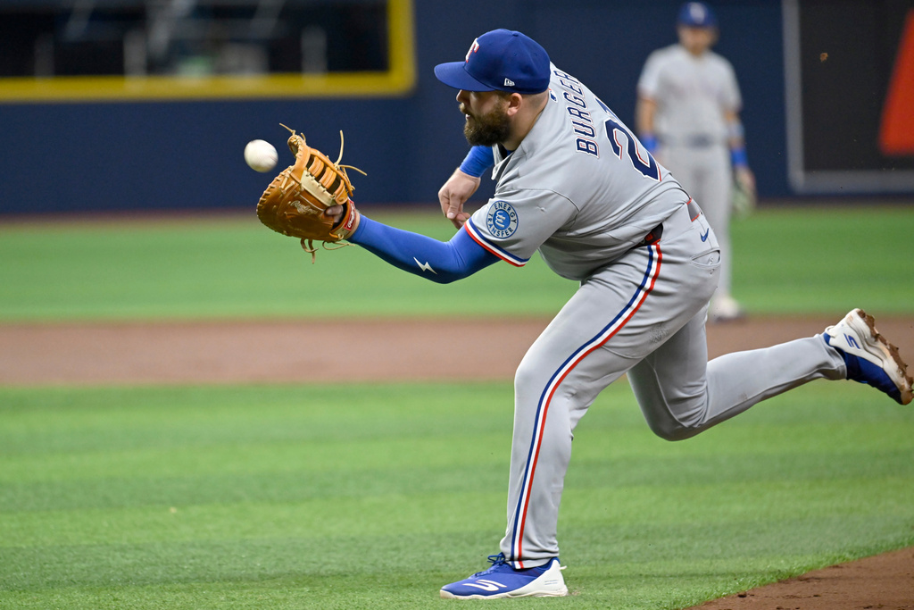 Texas Rangers first baseman Jake Burger catches a pop up hit by Tampa Bay Rays' Nick Fortes, not pictured, during the second inning of a baseball game Wednesday, July 29, 2026, in St. Petersburg, Fla. (AP Photo/Jason Behnken)