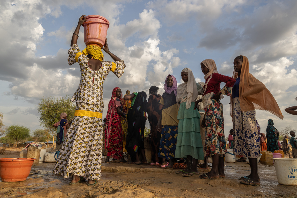 FILE - Women and children fetch water at dusk in the Korsi Refugee Camp in Birao, the Central African Republic, Friday, March 27, 2026. (AP Photo/Caitlin Kelly, File)