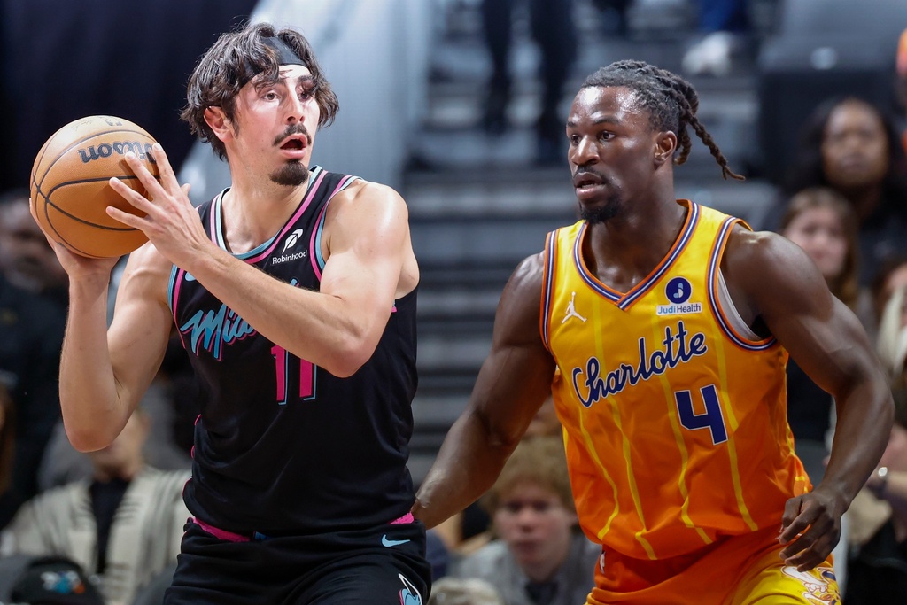 Miami Heat forward Jaime Jaquez Jr. (11) looks to pass the ball against Charlotte Hornets guard Sion James (4) during the first half of an NBA basketball game in Charlotte, N.C., Friday, March 6, 2026. (AP Photo/Nell Redmond)