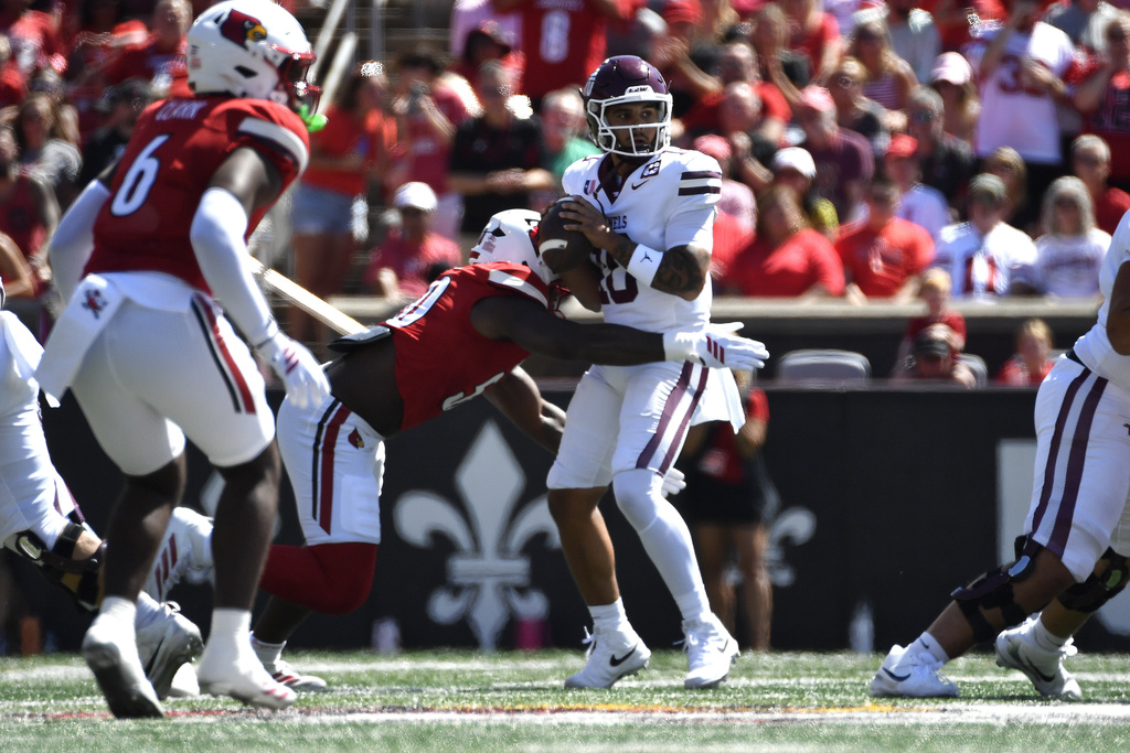 Louisville defensive lineman Clev Lubin (50) sacks Eastern Kentucky quarterback Myles Burkett (10) during the first half of an NCAA college football game in Louisville, Ky., Saturday, Aug. 30, 2025. (AP Photo/Timothy D. Easley)