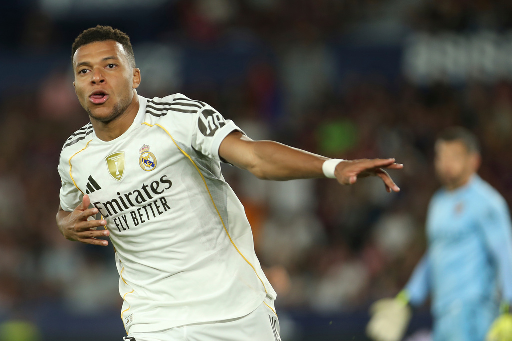 Real Madrid's Kylian Mbappe, celebrates after scoring his side's fourth goal with a penalty kick during the Spanish La Liga soccer match between Levante and Real Madrid at the Ciutat de Valencia stadium in Valencia, Spain, Tuesday, Sept. 23, 2025. (AP Photo/Alberto Saiz)