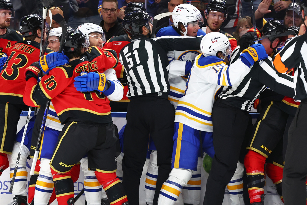 NHL Linesman Andrew Smith (51) attempts to separate Buffalo Sabres and Ottawa Senator players during the second period of an NHL hockey game Wednesday, Oct. 15, 2025, in Buffalo, N.Y. (AP Photo/Jeffrey T. Barnes)