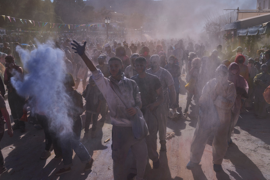 Revelers take part in the annual flour war marking the end of the Carnival season on Clean Monday in Galaxidi, about 200 kilometers (120 miles) west of Athens, Feb. 23, 2026, starting the 40-day Christian Lent fast leading to Easter. (AP Photo/Petros Giannakouris)