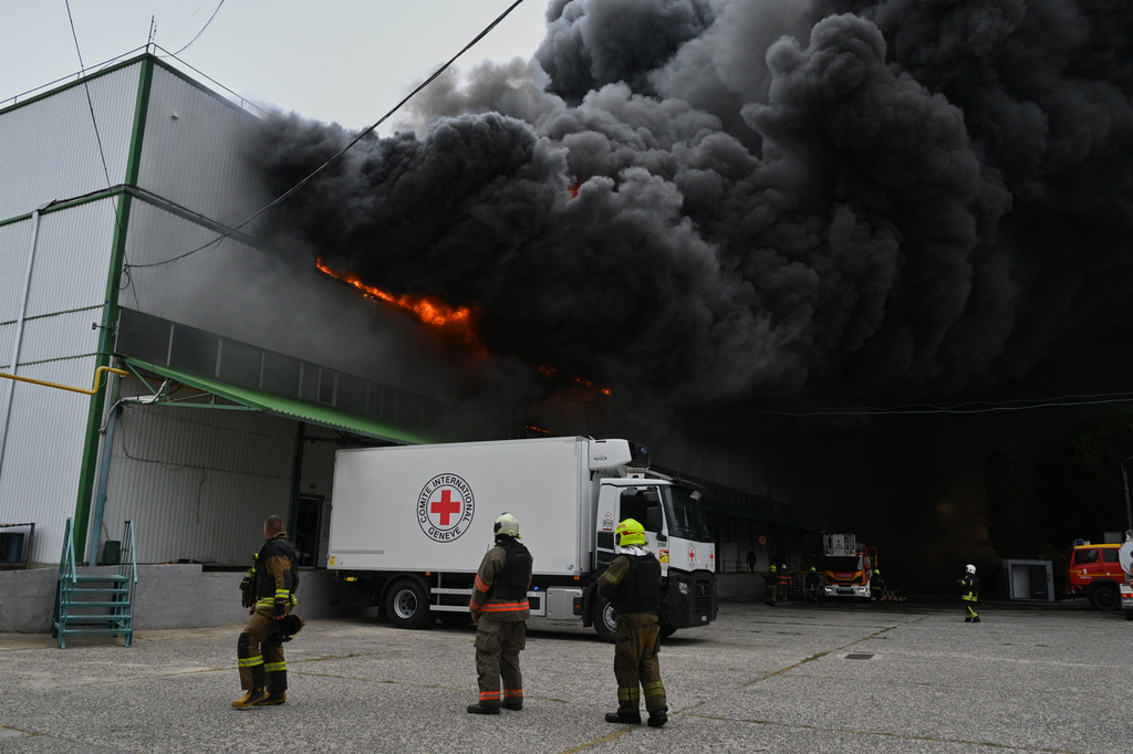 Firefighters put out a fire at warehouse stores after a Russian air attack in Odesa, Ukraine, Sunday, Sept. 13, 2026. (AP Photo/Michael Shtekel)