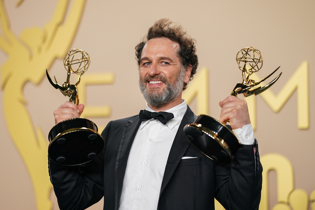 Matthew Rhys poses in the press room with the awards for outstanding lead actor in a limited or anthology series or movie for "The Beast In Me," and outstanding lead actor in a comedy series for "Widow's Bay" during the 78th Emmy Awards on Monday, Sept. 14, 2026, at the JW Marriott in Los Angeles. (Photo by Richard Shotwell/Invision/AP)