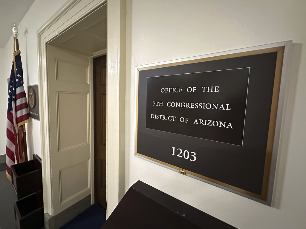 An American flag stands outside the office of the Arizona's 7th Congressional District, which has had a vacant seat since March 13 following the death of Democratic Rep. Raúl Grijalva, in Washington, Tuesday, Sept. 2, 2025. (AP Photo/Robert Yoon)