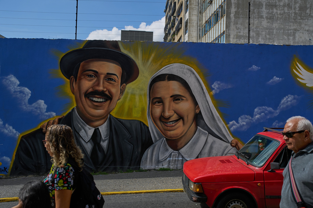 A mural features two late Venezuelans, Jose Gregorio Hernandez, the physician known as the "doctor of the poor", left, and Maria Carmen Rendiles in Caracas, Venezuela, Friday, Oct 17, 2025, both of whom will be canonized as Venezuela's first saints. (AP Photo/Ariana Cubillos)