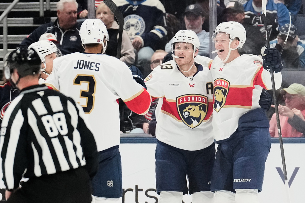 Florida Panthers left wing Brady Tkachuk, right, celebrates his goal against the Columbus Blue Jackets with Seth Jones (3) and Matthew Tkachuk (19) in the second period of an NHL hockey game in Columbus, Ohio, Tuesday, Oct. 13, 2026. (AP Photo/Sue Ogrocki)