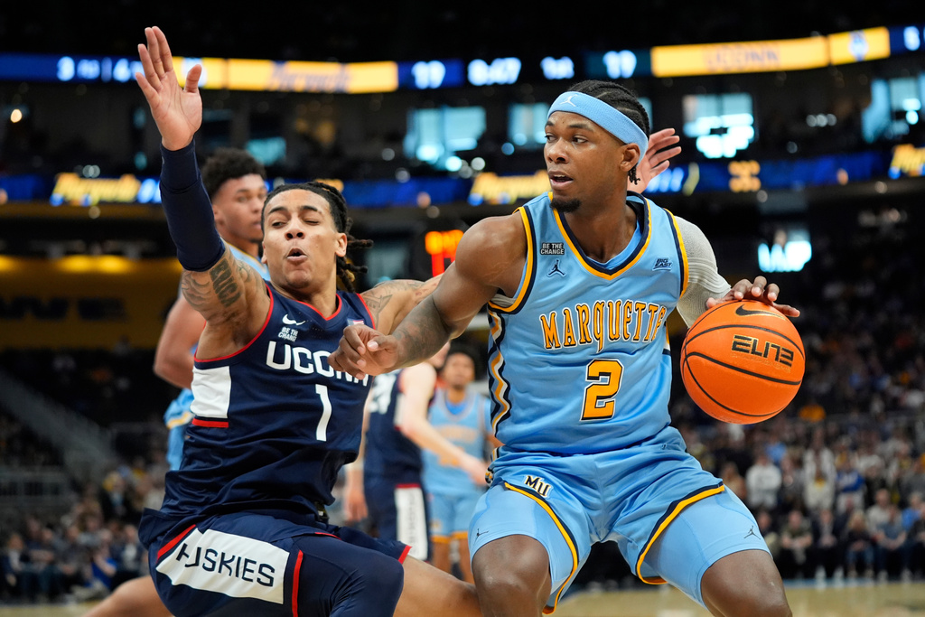 Marquette's Chase Ross (2) drives to the basket against UConn's Solo Ball during the first half of an NCAA college basketball game Saturday, March 7, 2026, in Milwaukee. (AP Photo/Aaron Gash)