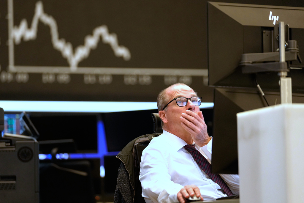 FILE - A trader sits on the trading floor of the Frankfurt Stock Exchange in front of the display board showing the DAX stock index in Frankfurt, Germany, April 9, 2025. (AP Photo/Martin Meissner, File)