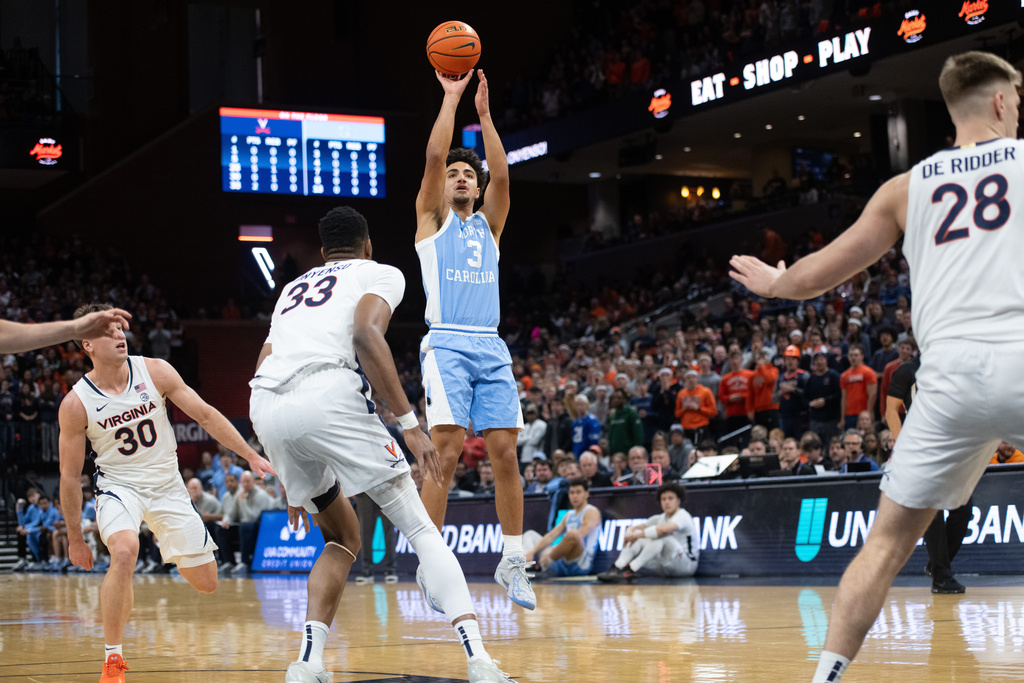 North Carolina guard Derek Dixon (3) takes a jump shot againt Virginia during the first half of an NCAA college basketball game, Saturday, Jan. 24, 2026, in Charlottesville, Va. (AP Photo/Robert Simmons)