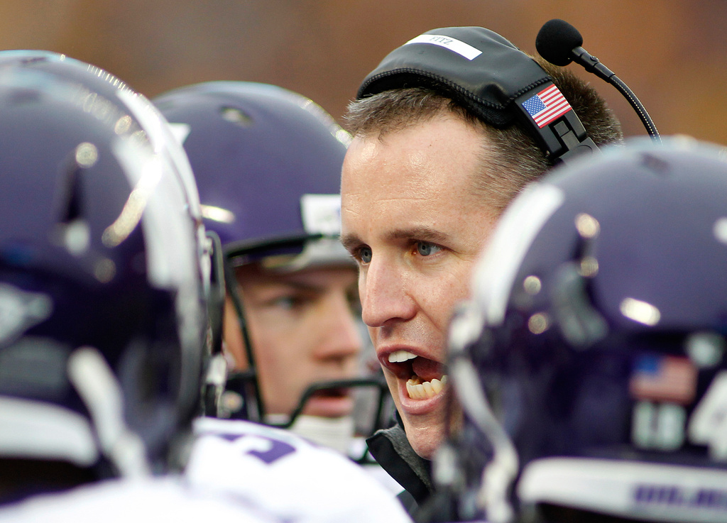 FILE - Northwestern head coach Pat Fitzpatrick talks to his players in the first half of a NCAA college football game against Minnesota in Minneapolis, Oct. 13, 2012. (AP Photo/Andy King, File)