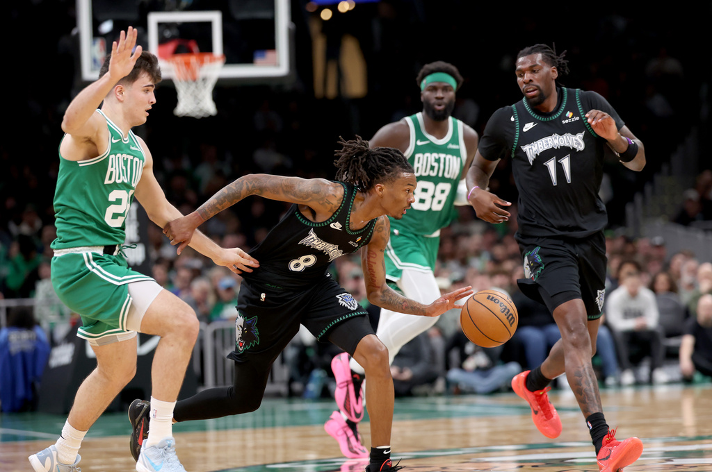 Minnesota Timberwolves guard Bones Hyland (8) dribbles the ball past Boston Celtics forward Hugo González (28) during the first half of an NBA basketball game, Sunday, March 22, 2026, in Boston. (AP Photo/Mark Stockwell)