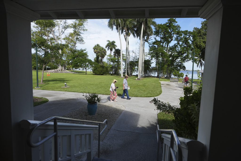 Visitors walk on the property of the Edison and Ford Winter Estates, Saturday, Aug. 9, 2025, in Fort Myers, Fla., which date from 1885, when Edison purchased the property to build a vacation home. (AP Photo/Lynne Sladky)