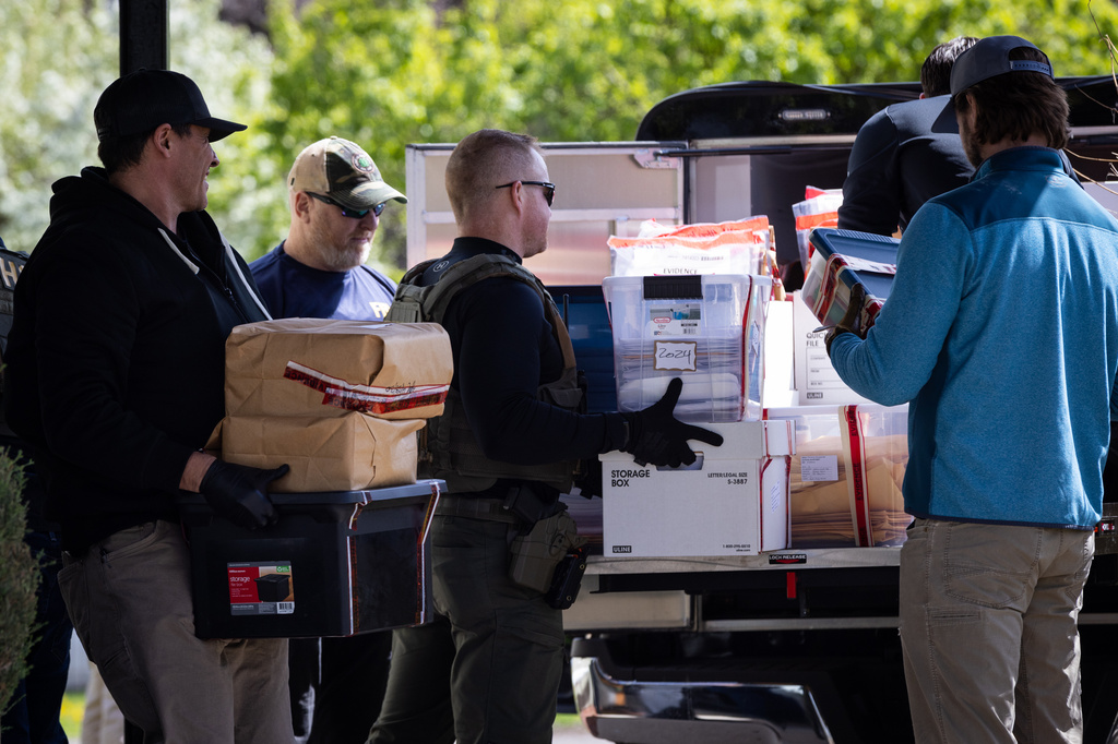 Federal and state officials load evidence into a vehicle as they execute a search warrant at The Original Childcare Center in south Minneapolis, Tuesday, April 28, 2026. (Ben Hovland/Minnesota Public Radio via AP)