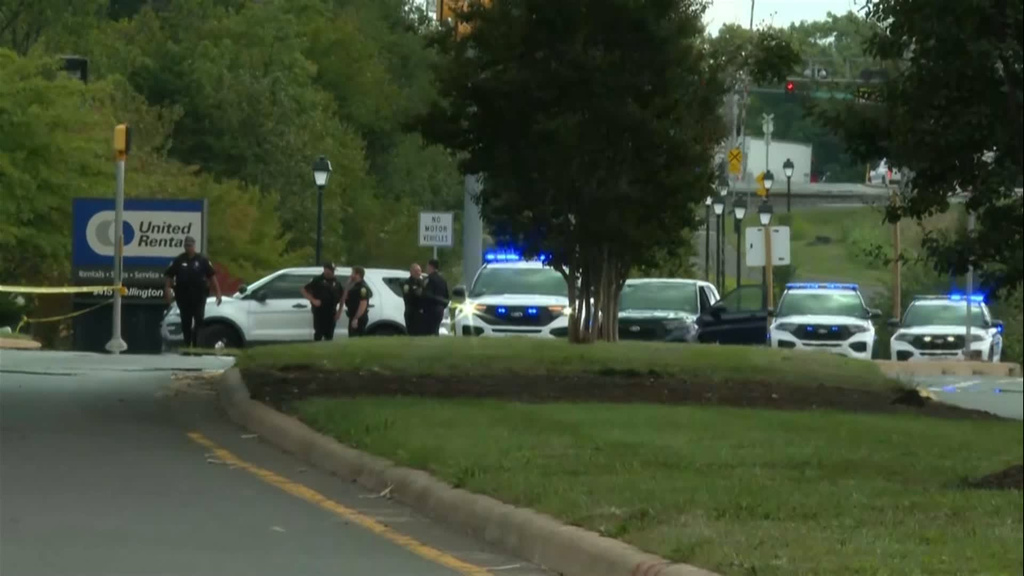 In this image from video provided by WJLA, police officers gather near the scene of a shooting in Manassas, Va., on Wednesday, Sept. 30, 2026. (WJLA via AP)