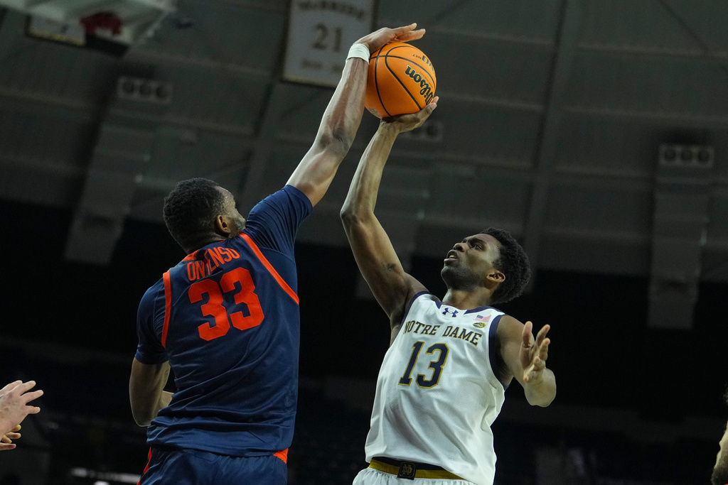 Virginia center Ugonna Onyenso (33) blocks the shot of Notre Dame guard Sir Mohammed (13) during the second half of an NCAA college basketball game in South Bend, Ind., Tuesday, Jan. 27, 2026. (AP Photo/Michael Conroy)