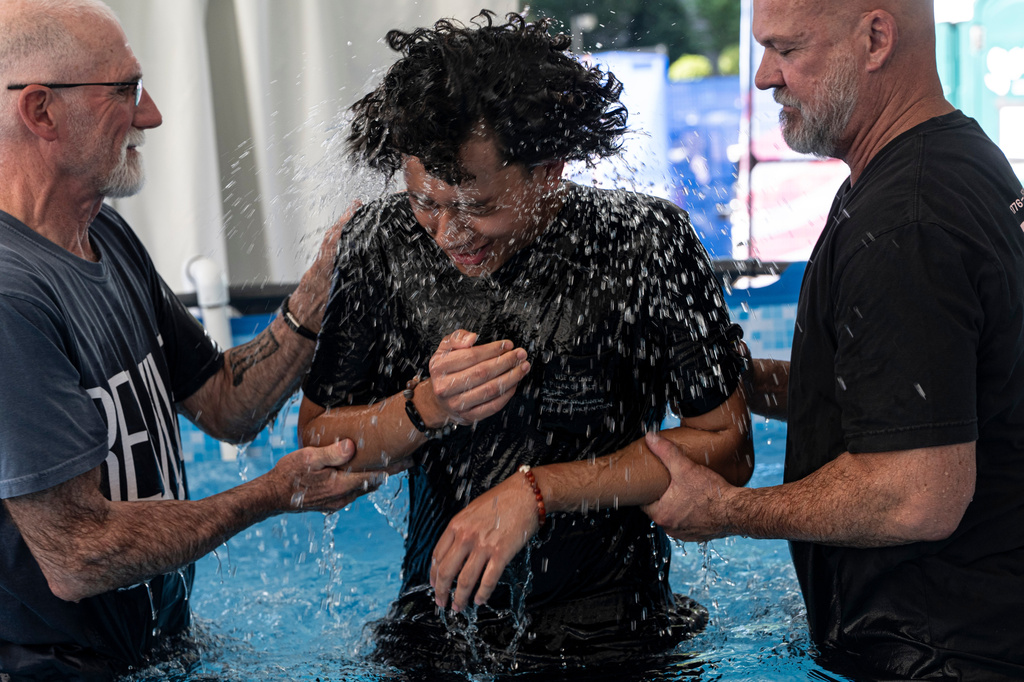A.J. Benasa of Carroll County, Md. is baptized in David's Tent at the Great American State Fair on the National Mall, Monday, June 29, 2026, in Washington. (AP Photo/Jen Golbeck)
