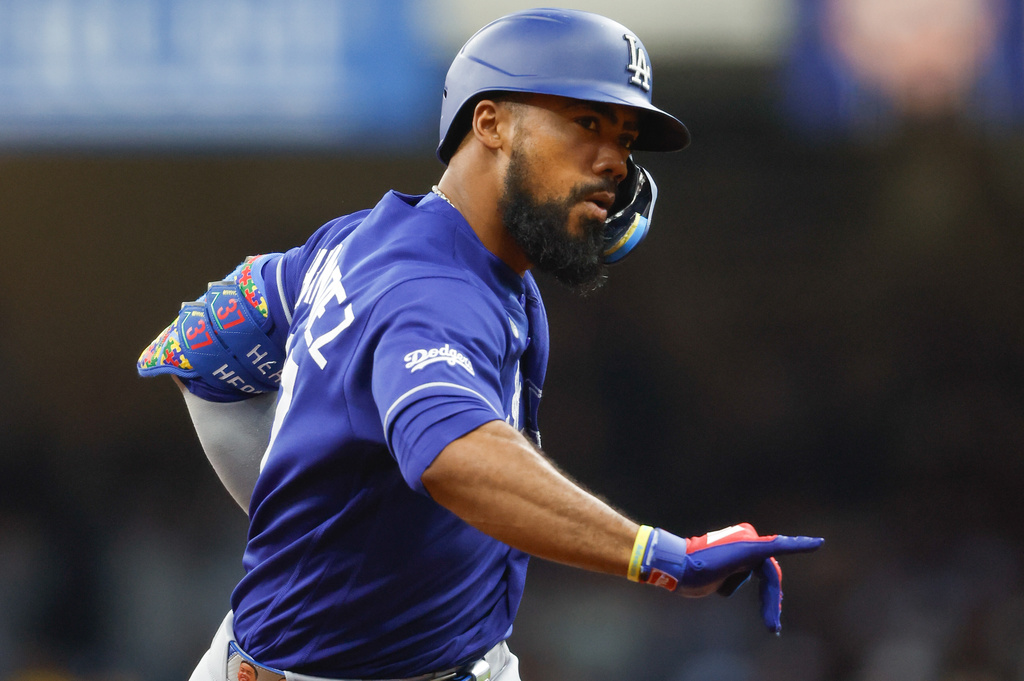 Los Angeles Dodgers' Teoscar Hernández reacts after hitting a three-run home run during the fourth inning of a baseball game against the Milwaukee Brewers, Saturday, May 23, 2026, in Milwaukee. (AP Photo/Jeffrey Phelps)