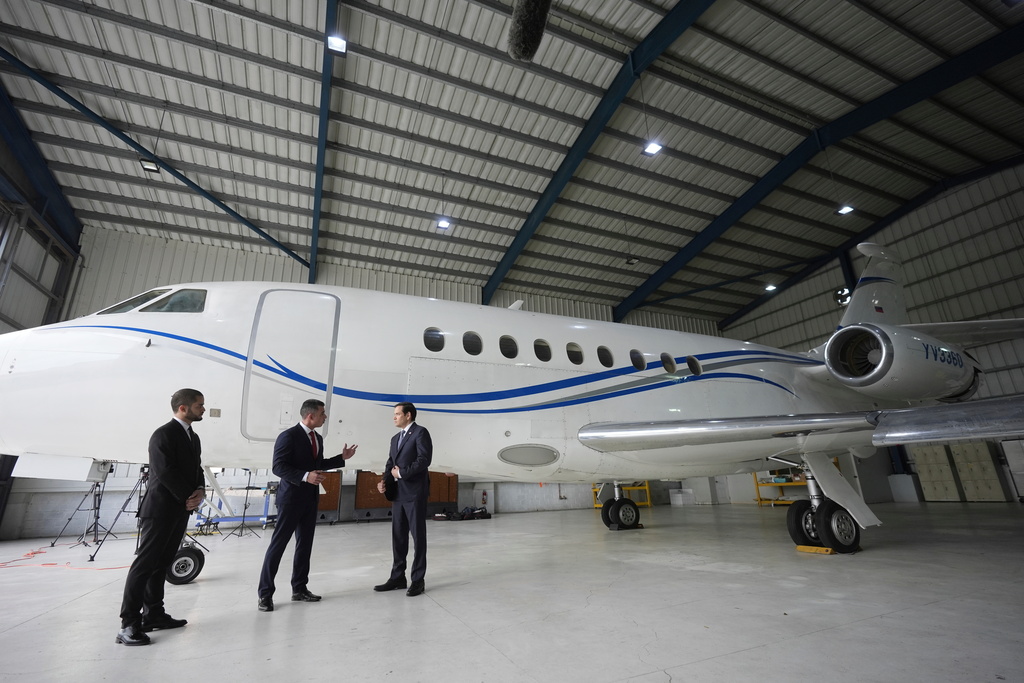 FILE - U.S. Secretary of State Marco Rubio, right, listens to Edwin F. Lopez, the attaché for DHS Homeland Security Investigations, center, next to the Venezuelan government airplane that Rubio announced is being seized by the U.S. during a news conference at La Isabela International Airport in Santo Domingo, Dominican Republic, Thursday, Feb. 6, 2025. At left is Dominican Public Prosecutor Enmanuel Ramirez. (AP Photo/Mark Schiefelbein, Pool, File)