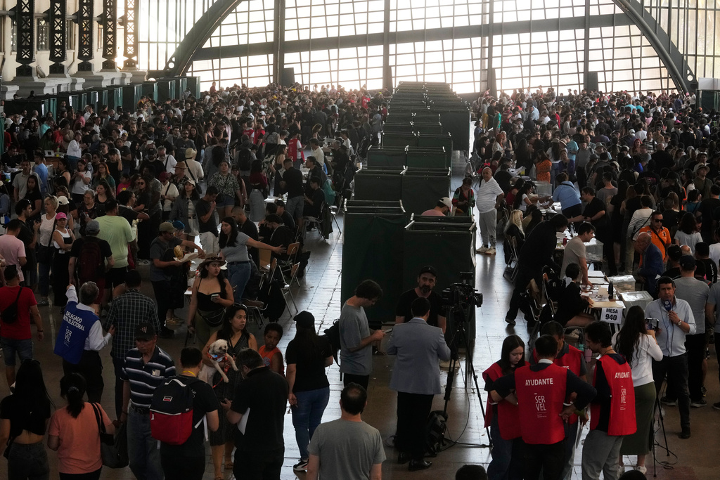 Voters stand inside a polling station during general elections in Santiago, Chile, Sunday, Nov. 16, 2025. (AP Photo/Esteban Felix)