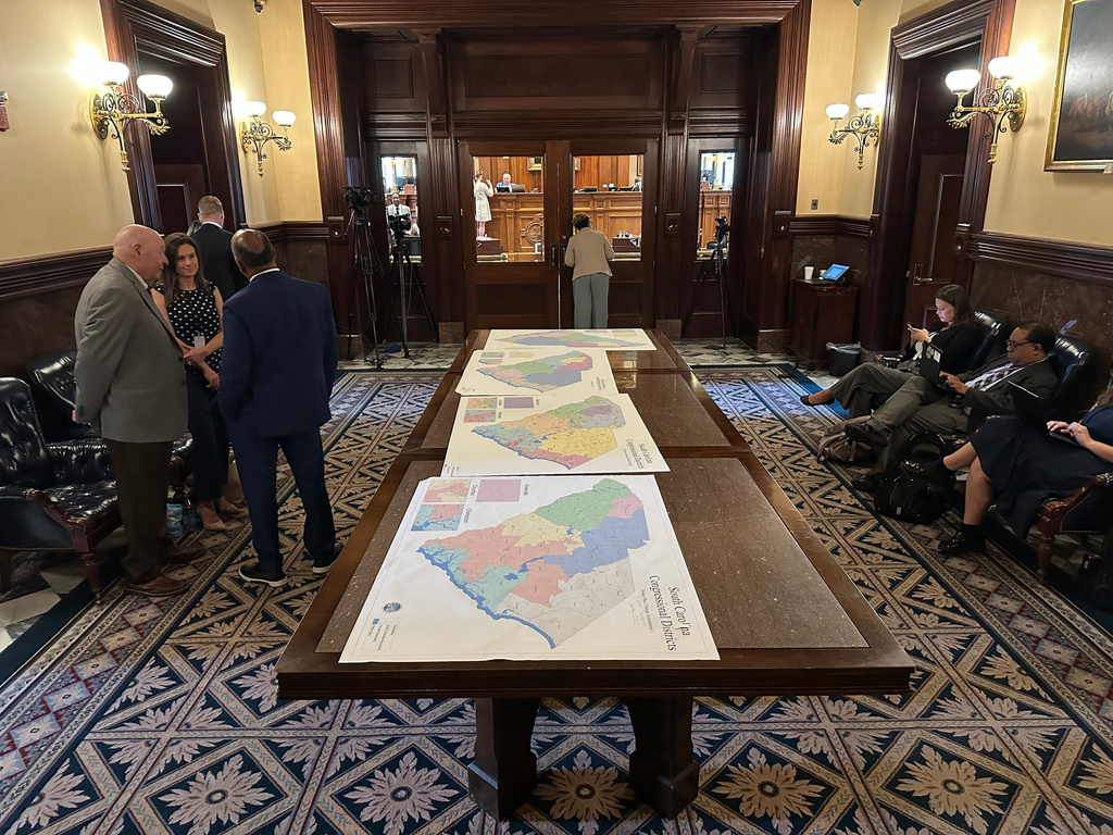 Maps for new congressional districts in South Carolina are shown in the South Carolina Senate antechamber on Friday, May 22, 2026, in Columbia, S.C. (AP Photo/Jeffrey Collins)