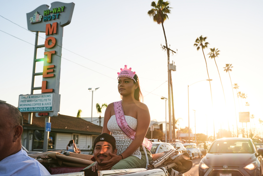 Lowriders cruise at the 6th Annual Lady Lowrider Cruise Night in celebration of International Women's Day in Pasadena, Calif., on Sunday, March 8, 2026. (AP Photo/Damian Dovarganes)
