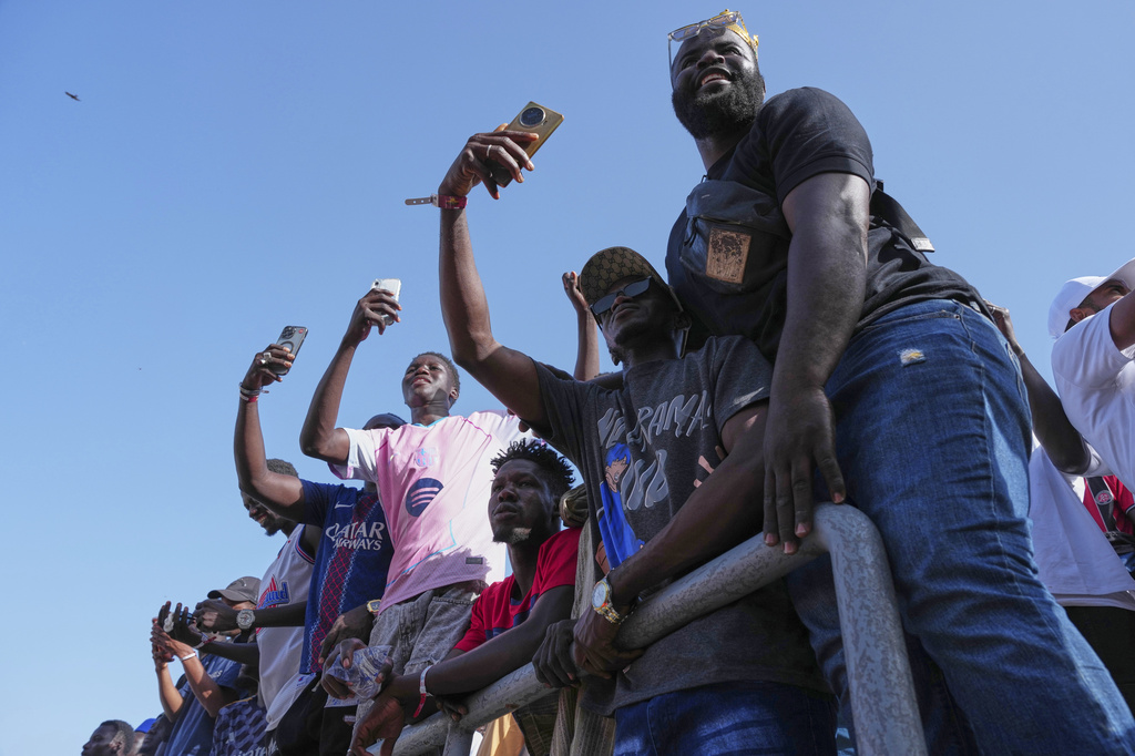Fans cheer at a wrestling competition at the National Arena in Dakar, Senegal, Sunday, April 5, 2026. (AP Photo/Misper Apawu)