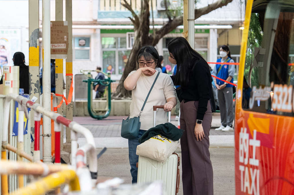 Residents react as they returned to their homes to collect belongings after the fire at Wang Fuk Court, a residential estate in the Tai Po district of Hong Kong's New Territories on Wednesday, Dec 3, 2025. (AP Photo/Chan Long Hei)