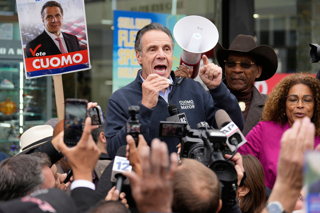 New York City mayoral candidate Andrew Cuomo speaks to a crowd of reporters and pedestrians while campaigning in New York, Monday, Nov. 3, 2025. (AP Photo/Seth Wenig)