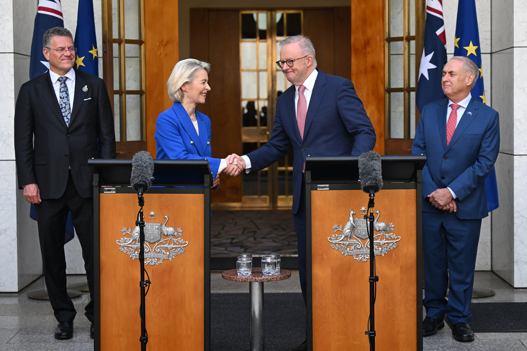European Commission President Ursula von der Leyen, center left, and Australian Prime Minister Anthony Albanese shake hands after an agreedment on the final text of a free trade agreement at Parliament House in Canberra, Tuesday, March 24, 2026, as EU Commissioner for Trade and Economic Security Maros Sefcovic, left, and Australian Minister for Trade, Don Farrell, right, look on. (Lukas Coch/AAP Image via AP)