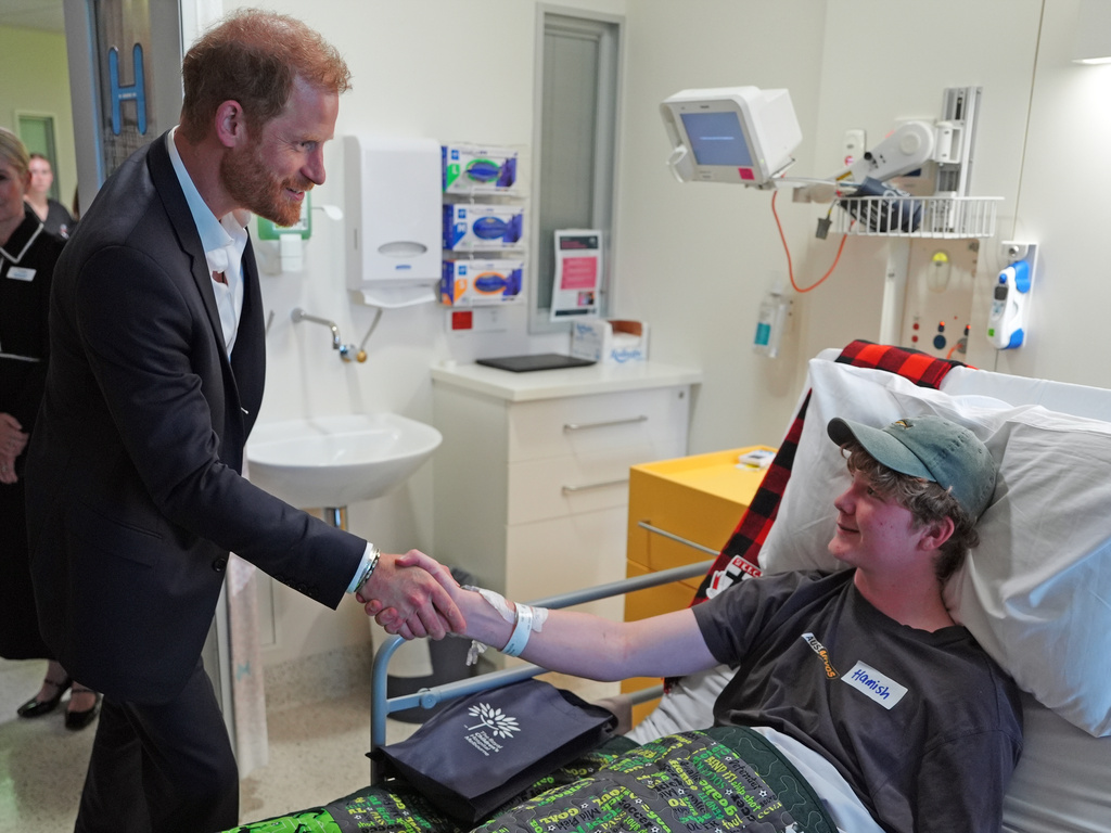 Britain's Prince Harry, the Duke of Sussex, meets patient Hamish on the Adolescent Oncology and Rehabilitation ward during a visit to the Royal Children's Hospital Melbourne, Australia Tuesday, April 14, 2026. (Jonathan Brady/Pool Photo via AP)
