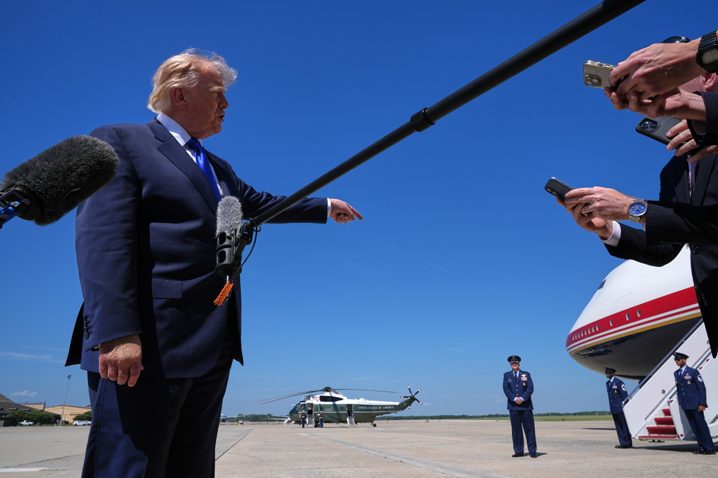 President Donald Trump talks with reporters after an emergency inflatable slide deployed on Air Force One before before Trump arrived to board at Joint Base Andrews, Md., Wednesday, Sept. 9, 2026. (AP Photo/Jacquelyn Martin)