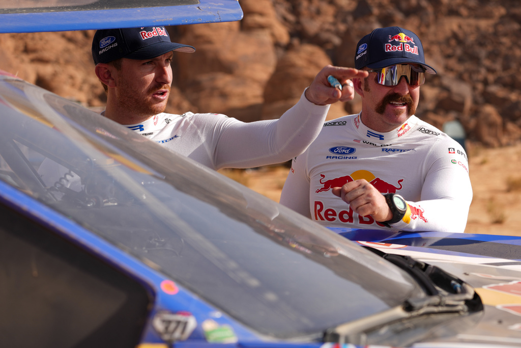 Driver Mitch Guthrie, left, and co-driver Kellon Walch talk after the fourth stage of the Dakar Rally between Alula and Hail, Saudi Arabia, Wednesday, Jan. 7, 2026. (AP Photo/Thibault Camus)