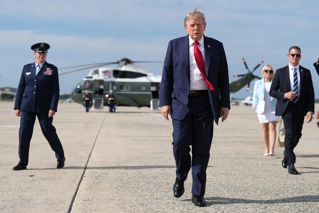 FILE - President Donald Trump, center, walks from Marine One to board Air Force One, Aug. 21, 2026, at Joint Base Andrews, Md., en route to South Carolina. (AP Photo/Jacquelyn Martin, File)