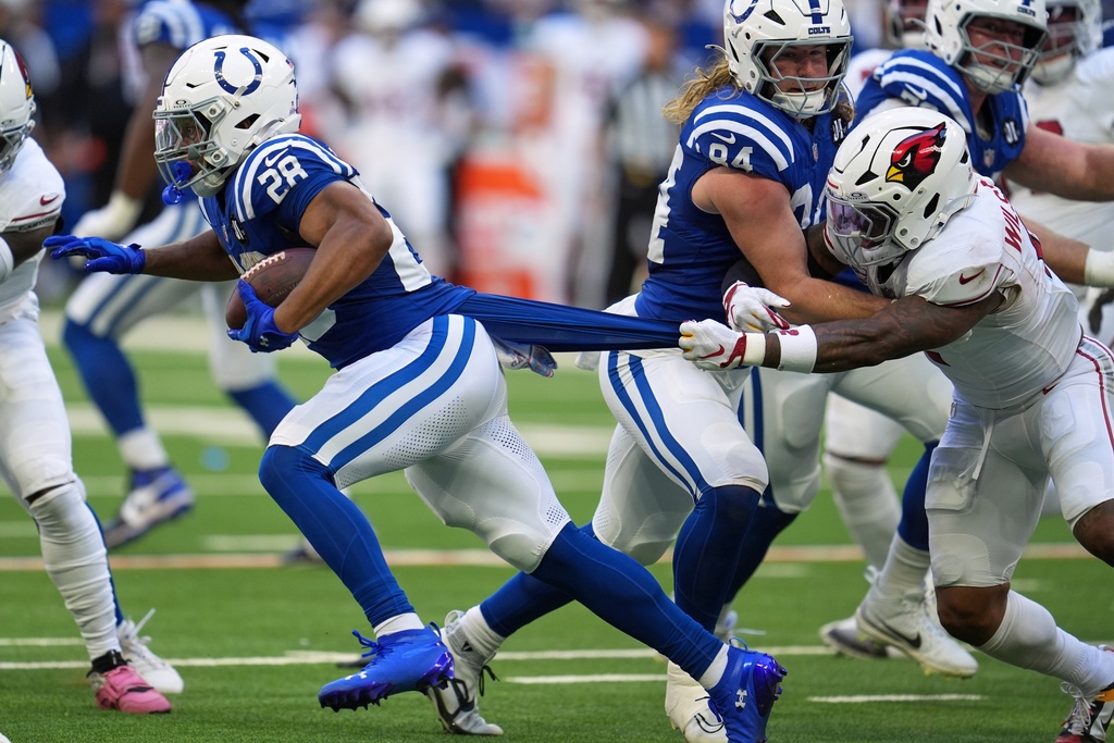 Arizona Cardinals' Mack Wilson stops Indianapolis Colts' Jonathan Taylor during the first half of an NFL football game Sunday, Oct. 12, 2025, in Indianapolis. (AP Photo/Michael Conroy)