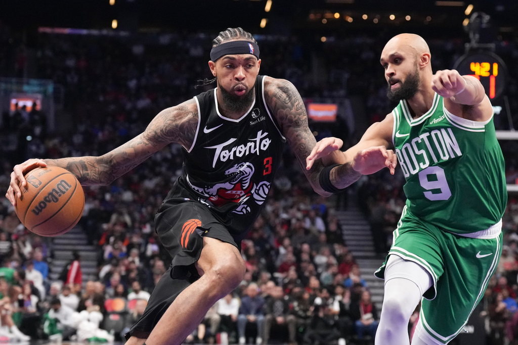 Toronto Raptors forward Brandon Ingram (3) drives against Boston Celtics guard Derrick White (9) during first-half NBA basketball game action in Toronto, Sunday Dec. 7, 2025. (Chris Young/The Canadian Press via AP)