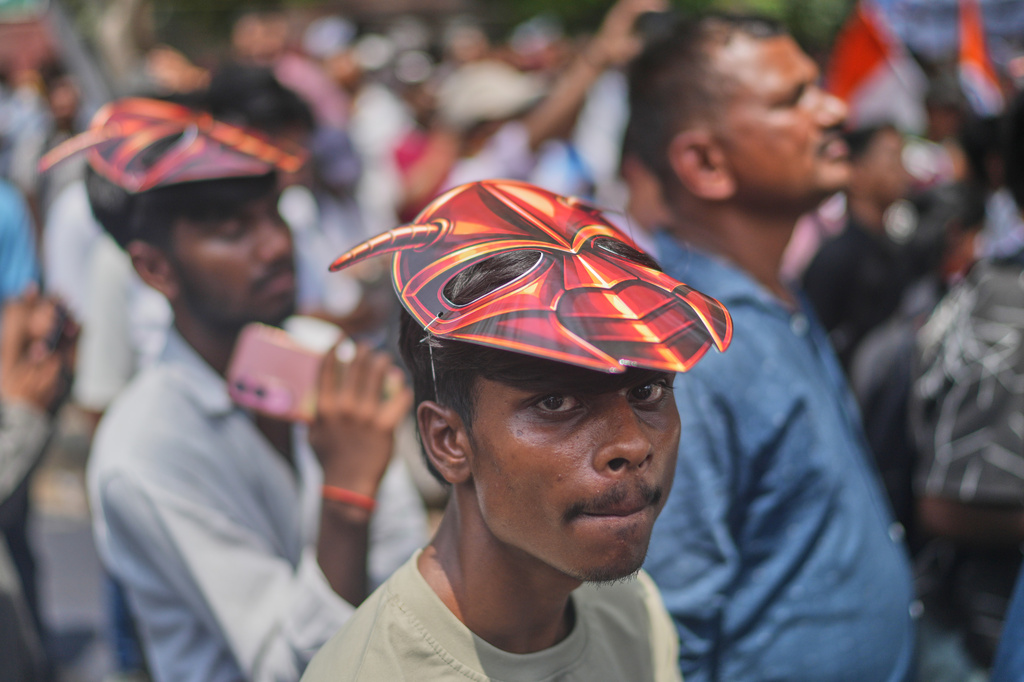 Supporters of the Cockroach Janta Party wear masks during a protest demonstration demanded the resignation of Education Minister Dharmendra Pradhan over alleged examination irregularities and repeated paper leaks in New Delhi, India, Saturday, June 20, 2026. (AP Photo/Manish Swarup)