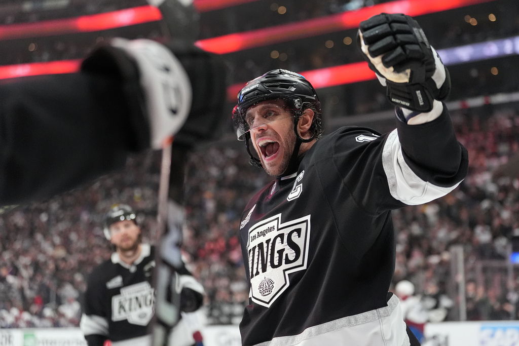 Los Angeles Kings' Anze Kopitar (11) celebrates a goal by Joel Edmundson against the Colorado Avalanche during the second period of Game 4 in the first round of an NHL hockey Stanley Cup playoff series Sunday, April 26, 2026, in Los Angeles. (AP Photo/Scott Strazzante)