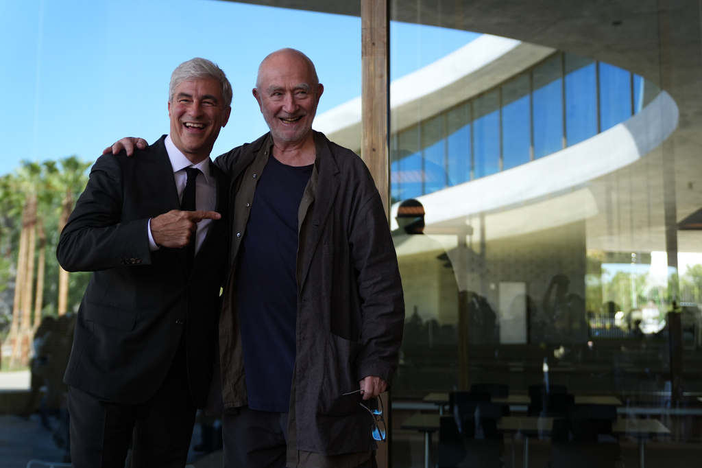 Michael Govan, CEO and Wallis Annenberg Director smiles with architect Peter Zumthor during the opening ceremonies of the Los Angeles County Museum of Art, speaks at the podium during the inaugural opening of the David Geffen Galleries on Wednesday, April 15, 2026. (AP Photo/Damian Dovarganes)