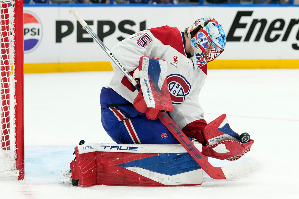 Montréal Canadiens goaltender Jakub Dobes (75) makes a glove save on a shot by the Tampa Bay Lightning during the second period in Game 1 of an NHL hockey Stanley Cup first-round playoff series, Sunday, April 19, 2026, in Tampa, Fla. (AP Photo/Chris O'Meara)