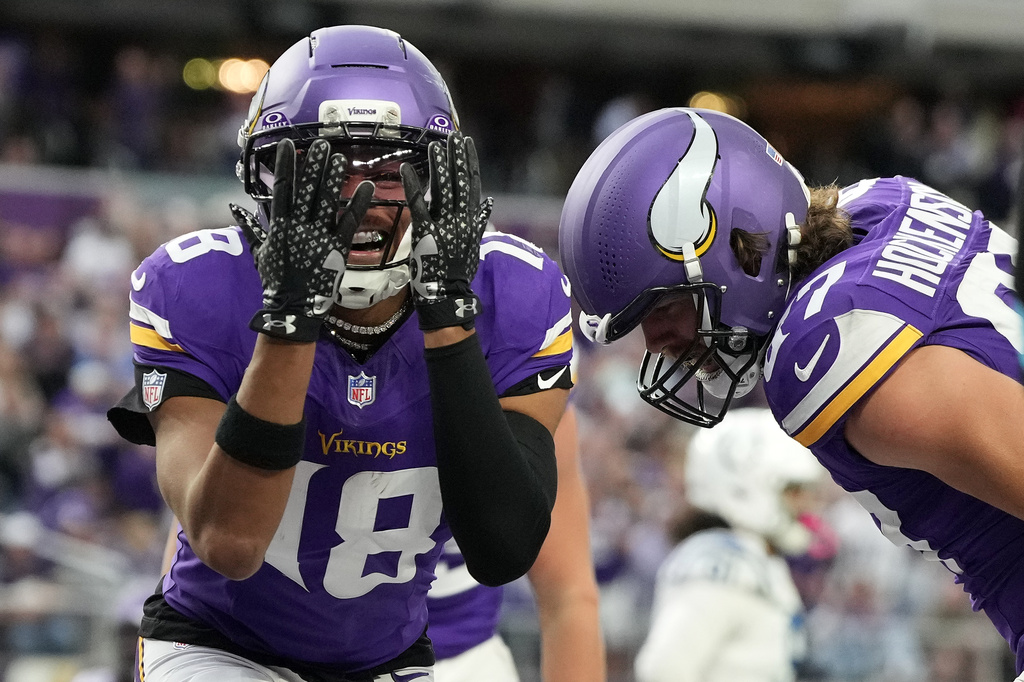 Minnesota Vikings wide receiver Justin Jefferson (18) celebrates after a touchdown by tight end T.J. Hockenson, right, during the second half of an NFL football game against the Indianapolis Colts in Minneapolis, Sunday, Oct. 25, 2026. (AP Photo/Ellen Schmidt)