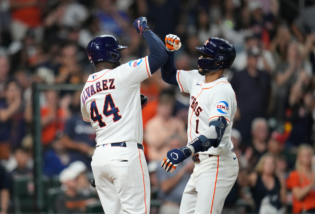 Houston Astros' Carlos Correa (1) celebrates his home run with Yordan Alvarez (44) during the sixth inning of a baseball game against the New York Yankees, Saturday, April 25, 2026, in Houston. (AP Photo/Karen Warren)